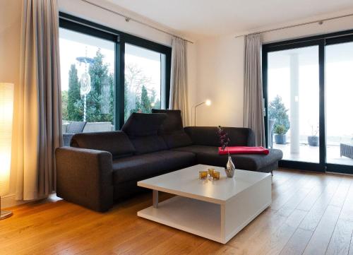 a living room with a couch and a coffee table at Villa Friede Marie FeWo Hannah in Sassnitz