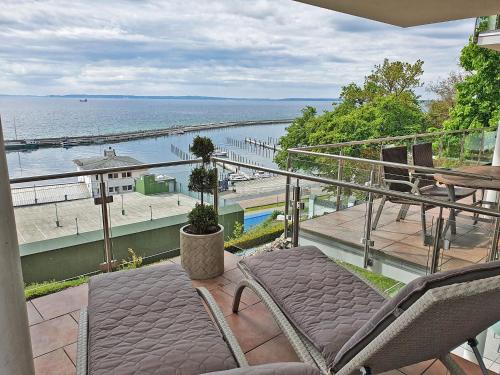 a balcony with chairs and a view of the water at Villa Friede Marie FeWo Svea in Sassnitz