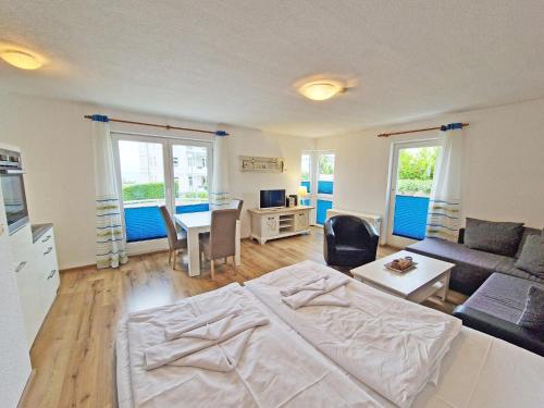 a living room with a bed and a table at Villa Monika Backbord 2 in Sassnitz