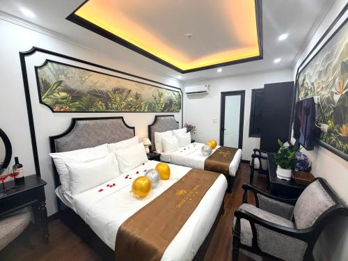 a hotel room with a bed and a table and chairs at Green Luxury Hanoi Hotel in Hanoi