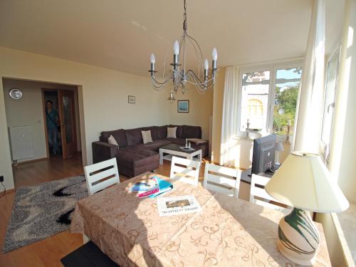 a living room with a table and a couch at Villa Seeblick - Apartment 309 in Sassnitz