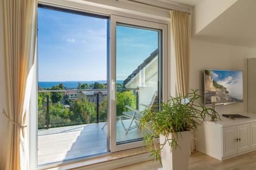 a large glass door with a view of a balcony at Villa am Kreidebruch - Ostseeweitblick in Sassnitz