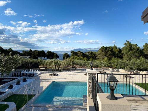 a swimming pool in a resort with a view at Villa Maginja in Sutivan