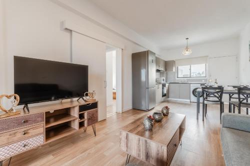 a living room with a large flat screen tv at Beachside Hideaway Apartment, 200m to the Havana Beach in Pyla