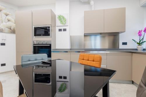 a kitchen with a table with two stools at La Suite Nel Borgo - Ai Piedi delle Alpi&Centro Storico in Borgo San Dalmazzo