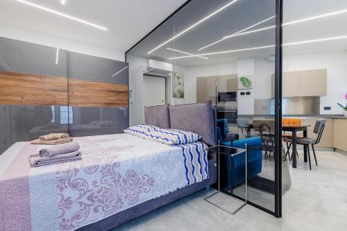 a bedroom with a bed and a dining room at La Suite Nel Borgo - Ai Piedi delle Alpi&Centro Storico in Borgo San Dalmazzo