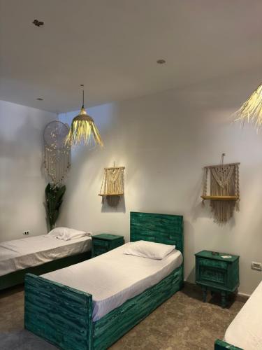 a room with two beds and two night stands at Studio In DaHaB in Dahab
