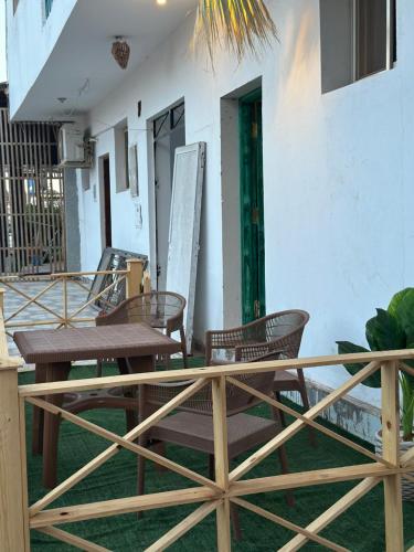 a patio with chairs and a table and a door at Studio In DaHaB in Dahab