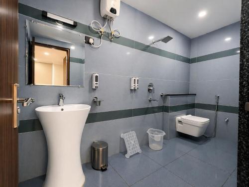 a bathroom with a sink and a toilet at Kripalu Care Foundation in Vrindāvan