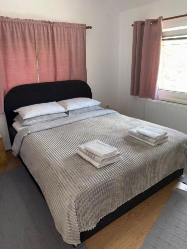 a bedroom with a bed with two towels on it at Apartman za odmor Plivska Jezera in Jajce