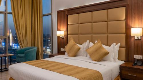 a hotel room with a bed and a large window at Terrace Alzahra تيراس الزهرا in Jeddah