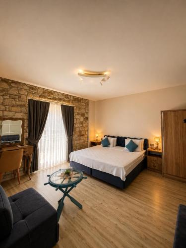 a hotel room with a bed and a couch at F&G Alaçatı in Alaçatı
