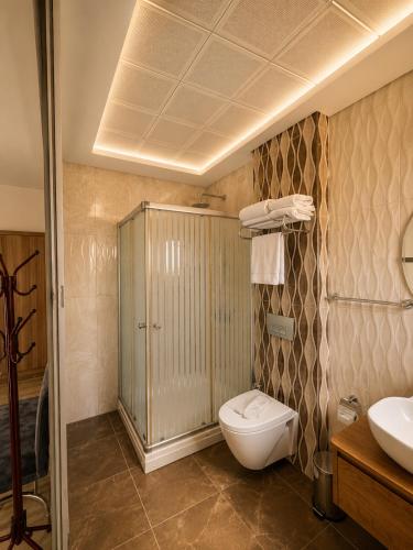 a bathroom with a toilet and a sink at F&G Alaçatı in Alaçatı