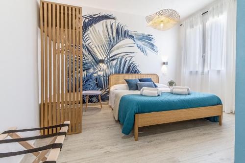 a bedroom with a bed and a palm tree mural at NURAS - Affittacamere L'Azzurra - Double bedrooms private bathroom and seaview solarium in Sorso
