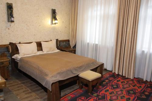 a bedroom with a bed and a window at Senger Qala Riverside in Qax