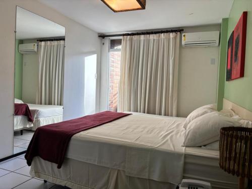 a bedroom with a large bed and a window at Gran Lençóis in Barreirinhas