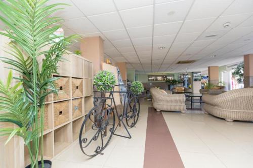 a bike is parked in a lobby with plants at BLUESEA Veril Playa in Playa del Ingles
