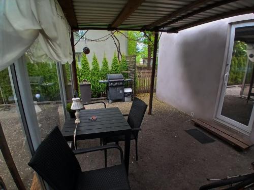 a patio with a table and chairs and a grill at Forrent-ee in Pärnu