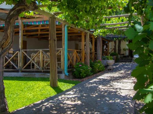 a garden with a wooden pergola and a walkway at Hazeldene Accommodation in Colesberg
