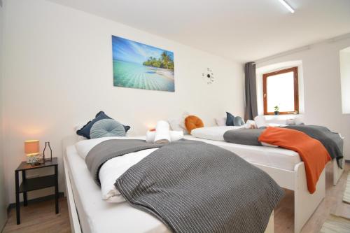 a bedroom with three beds with towels on them at Apartments in Ebrach am Kloster in Ebrach