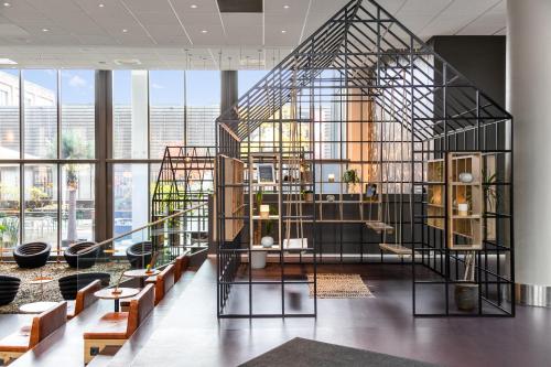 a spiral staircase in a room with windows at Comfort Hotel Union Brygge in Drammen