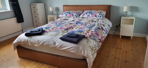 a bedroom with a bed with two towels on it at Ox Mountain View 3 Bed apartment in Foxford