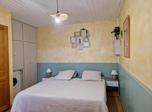 a bedroom with a white bed with two pillows at Gîte Le Devant De La Chaux in Pontaix