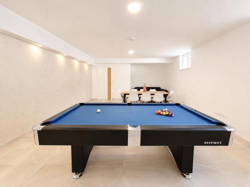 a pool table in the middle of a room at Orebic Luxury Villa Leopold in Orebić