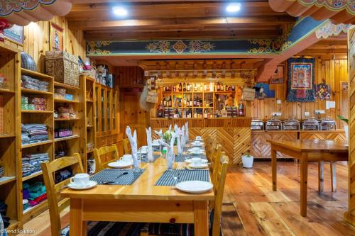 a dining room with a long table and chairs at Valley Resort in Jakar