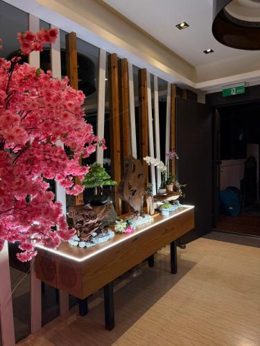 a table with flowers on it in a room at Love's World B&B in Ji'an