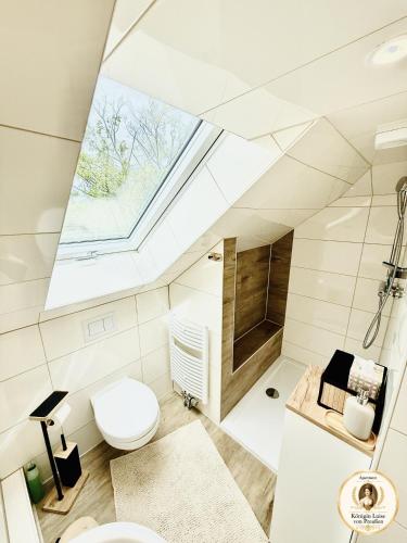 a bathroom with a skylight in the ceiling at Parkresidenz Viktoria Luise in Bad Salzuflen