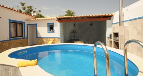 a swimming pool in front of a house at Viila Fernandes with Pool in Pera in Pêra