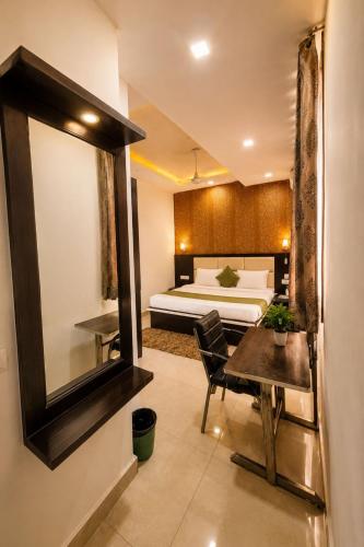 a hotel room with a bed and a table and a bedroom at Hotel Embassy Star Taaj Agra - Budget Ac Rooms Near Taj in Agra