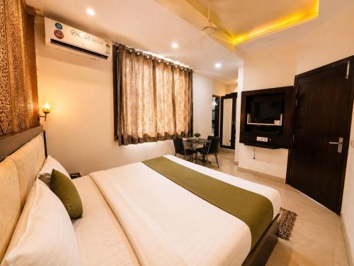 a hotel room with a bed and a television at Hotel Embassy Star Taaj Agra - Budget Ac Rooms Near Taj in Agra