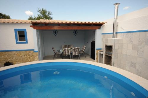 a swimming pool in front of a house at Viila Fernandes with Pool in Pera in Pêra