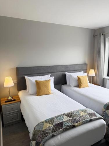 two beds sitting next to each other in a bedroom at Balreask Bar, Restaurant & Guest Accommodation in Navan