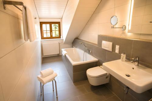 a white bathroom with a sink and a toilet at Roserhof Gengenbach in Gengenbach