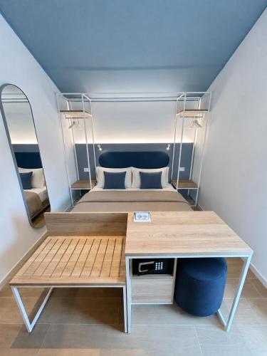 two beds in a small room with a desk at Almara Green Hotel in Rimini