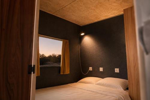a bedroom with two beds and a window at Belgian GP 2026 Fast Access The Hilltop Lodge in Amblève