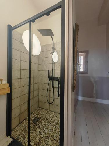 a shower with a glass door in a bathroom at Rosemar in Peyriac-de-Mer