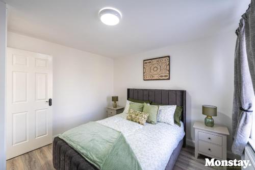 a bedroom with a bed and a white wall at Walled City House in Derry Londonderry