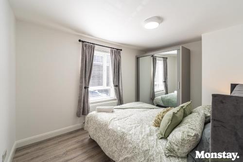 a bedroom with a bed and a large mirror at Walled City House in Derry Londonderry