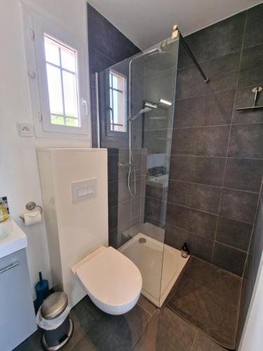 a bathroom with a shower with a toilet and a sink at Studio Villa Monica in Vallauris