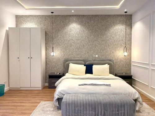 a bedroom with a large bed with two pillows at Luxury 1 BR With Swimming Pool & 24 Hours Security In Lekki 1 in Lagos