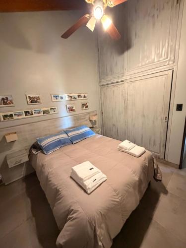 a bedroom with a bed with a ceiling fan at Mi hogar in Guaymallen