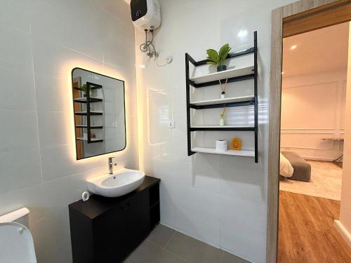 a bathroom with a sink and a mirror at Luxury 1 BR With Swimming Pool & 24 Hours Security In Lekki 1 in Lagos