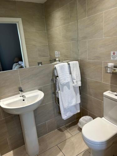 a bathroom with a sink and a toilet at Loch Ness Guest House in Fort Augustus