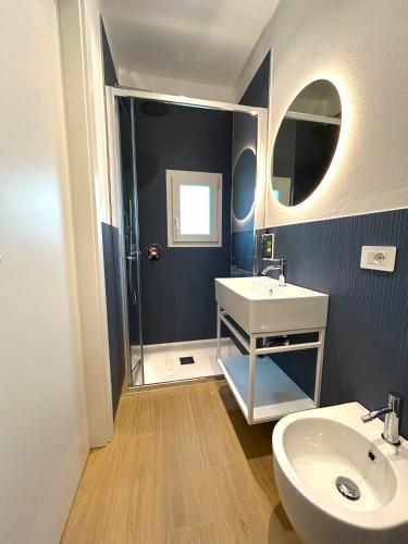 a bathroom with a sink and a mirror at Almara Green Hotel in Rimini