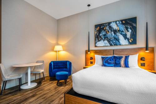 a hotel room with a bed and a table at Hotel Royal William, an Ascend Collection Hotel in Quebec City