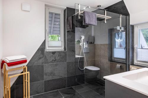 a bathroom with a shower and a sink at Ferienwohnung Schrödter in Schramberg